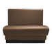 A brown leather booth with black legs.