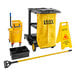 A Lavex Premium black janitor cart with mop bucket and yellow bags.