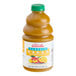 A bottle of Dr. Smoothie Classic Mango Fruit Smoothie Mix on a table in a smoothie shop.