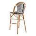 A Lancaster Table & Seating Bistro Rattan Counter Height Barstool with a gray and white chevron weave backrest.