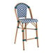 A Lancaster Table & Seating navy and white chevron weave rattan counter height barstool.