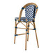 A Lancaster Table & Seating navy and white chevron weave rattan barstool.