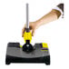 A person using a Karcher yellow and grey cordless floor sweeper to clean the floor.