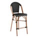 A Lancaster Table & Seating black Teslin counter height barstool with a black seat.