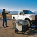 A man using a Karcher electric pressure washer to clean a white truck.