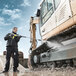 A man using a Karcher electric pressure washer to clean a vehicle.