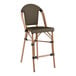 A brown Lancaster Table & Seating outdoor counter height barstool with a metal frame and a Teslin seat.