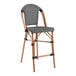 A Lancaster Table & Seating black and white outdoor restaurant barstool with a black seat.