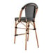 A Lancaster Table & Seating black and white barstool with a backrest and seat.
