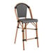 A black and white woven rattan bar stool with a checkered pattern.