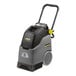 A black and grey Karcher BRC 30/15 C walk behind carpet extractor with wheels and a handle.