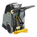 A Karcher walk behind carpet extractor with a yellow cord.