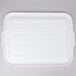 A white plastic Vollrath Traex food storage box lid with lines and handles.
