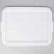 A white plastic Vollrath Traex lid with a few circles on the surface.