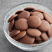 A bowl of Guittard milk chocolate wafers.