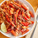 A plate of food with rice, meat, and Goya Los Andes IQF Rocoto Red Hot Peppers.