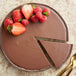 A close up of a chocolate cake with strawberries on top.