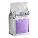 A white and purple bag of Guittard Eclipse du Soleil Milk Chocolate Wafers.