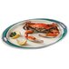 A crab on a GET Freeport oval platter with lemon wedges.