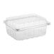 A D&W Fine Pack clear plastic clamshell produce container with a lid.