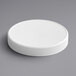 A 120/400 white plastic cap with foam liner on a gray surface.