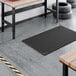 A heavy-duty black rubber anti-fatigue floor mat with a diamond pattern and straight edges, measuring 3 feet by 5 feet and 3/4 inch thick.