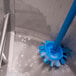 A blue Vikan tank brush head cleaning a metal sink.