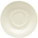 A close-up of a white saucer with a rippled rim.