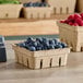 A row of Choice produce baskets filled with blueberries and raspberries.
