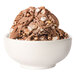 A bowl of Tillamook Rocky Road ice cream with chocolate and marshmallows.