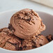 A bowl of Tillamook Mudslide ice cream with chocolate chunks.