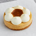 A White Toque caramel cheesecake tartlet with white and brown toppings.