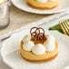 A White Toque gluten-free caramel cheesecake tartlet on a white plate.