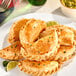A plate of White Toque ready-to-bake empanada dough discs with baked empanadas.