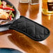 A black cloth cover on a pot handle.