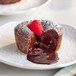 A White Toque chocolate lava cake with a raspberry on top.