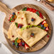 A White Toque crepe with berries on a wooden board.