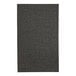 A close-up of a black fabric menu cover with a textured pattern.