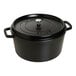 A black Staub enameled cast iron casserole with lid.