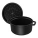A black Staub enameled cast iron Dutch oven with a lid.