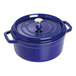 A dark blue Staub enameled cast iron pot with a lid.
