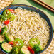 A bowl of Lotus Foods Organic Millet and Brown Rice Ramen with broccoli and peppers.