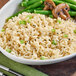 A bowl of Lotus Foods long grain brown jasmine rice with green beans and mushrooms.