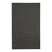 A close-up of a black fabric menu cover with a pattern.