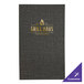 A black H. Risch, Inc. menu cover on a table with a purple and white sign in the background.
