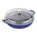 A dark blue enameled cast iron pot with a clear glass lid.