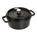 A black Staub enameled cast iron dutch oven with a lid.
