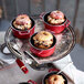 A small red Staub enameled cast iron pot with a donut in it.