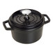 A black Staub enameled cast iron mini Dutch oven with a lid.