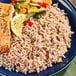 A plate of Lotus Foods Organic Tricolor Blend rice with salmon and vegetables.